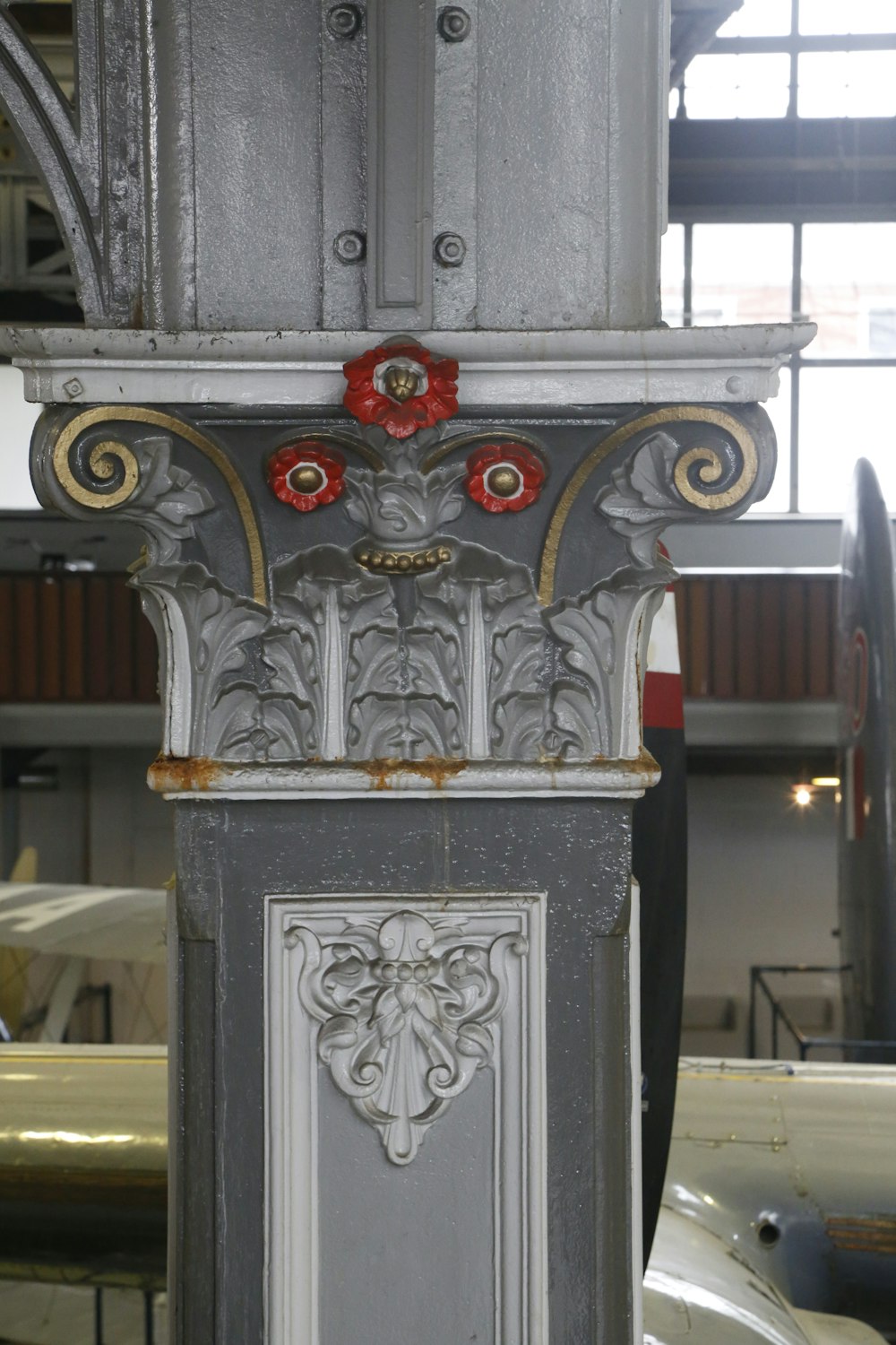 a close up of a metal object with a red flower on it