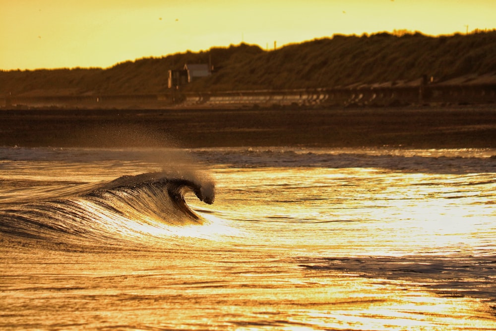 a person riding a wave on top of a surfboard