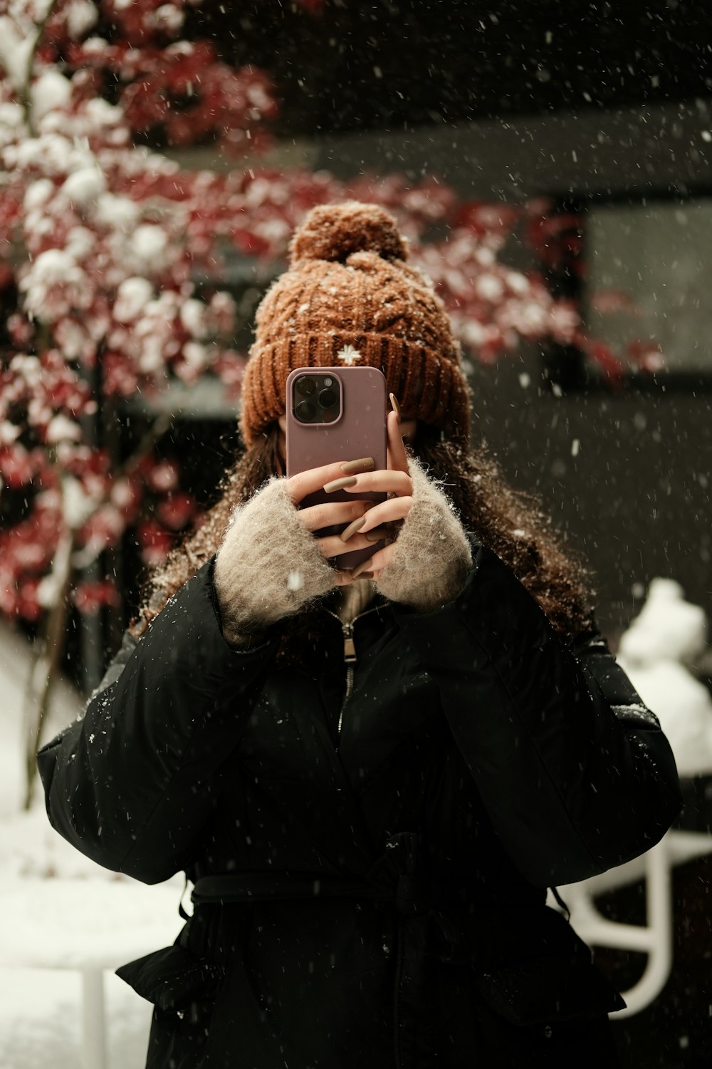 a woman taking a picture of herself in the snow