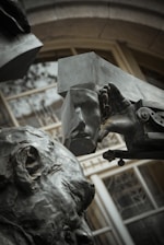 Close-up of a bronze abstract sculpture with gold highlights on a green velvet background.