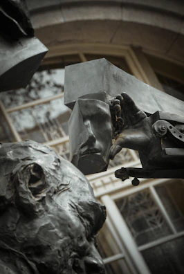 Close-up of a bronze sculpture element integrated within a dark luxury interior environment.