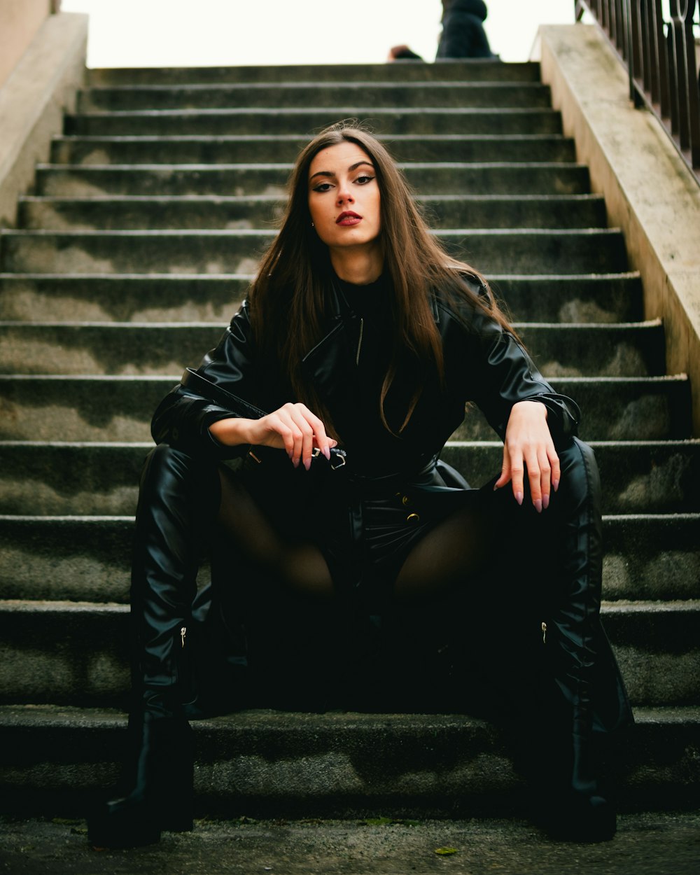 a woman sitting on a set of stairs