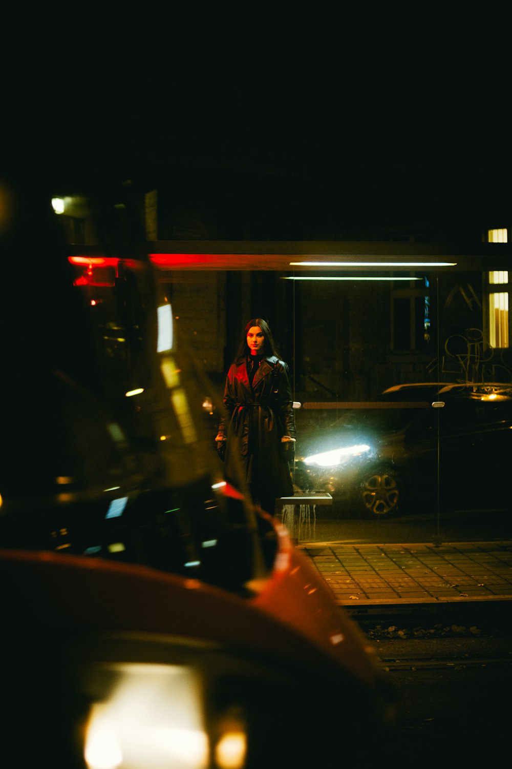 a man standing on the side of a road at night