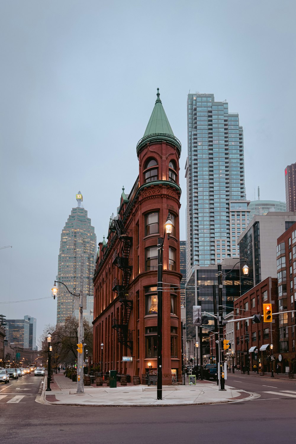 a red building with a green roof on a city street