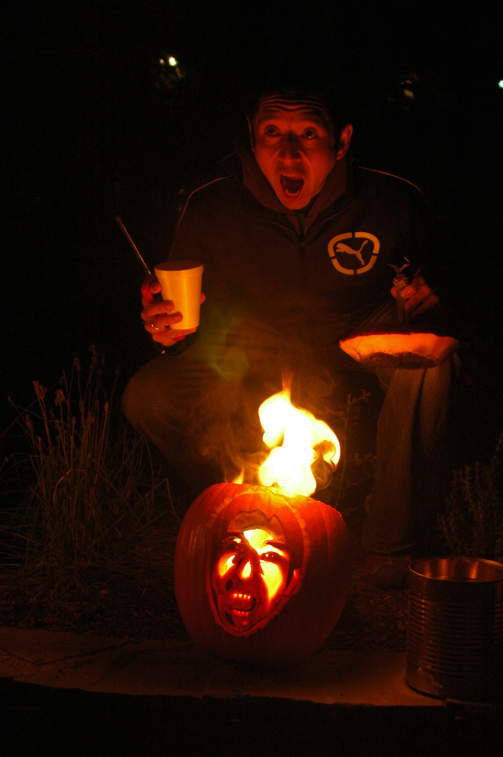 a man sitting on top of a carved pumpkin