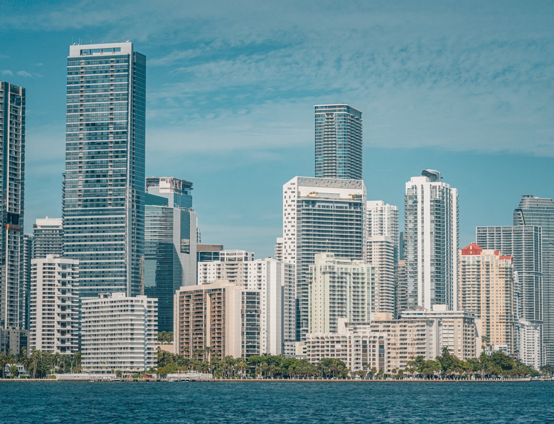 a large body of water with a city in the background, Brickell Miami