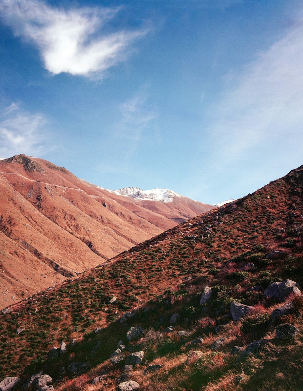 a view of a mountain range with a cloud in the sky