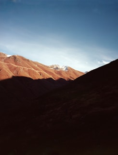 A picturesque mountain landscape under a clear blue sky.