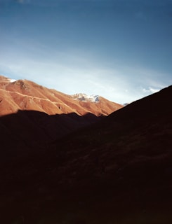 A picturesque mountain landscape under a clear blue sky.