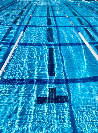 Bright and clean swimming pool with lane dividers and swim equipment