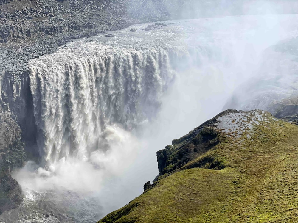 a view of a waterfall from the top of a hill