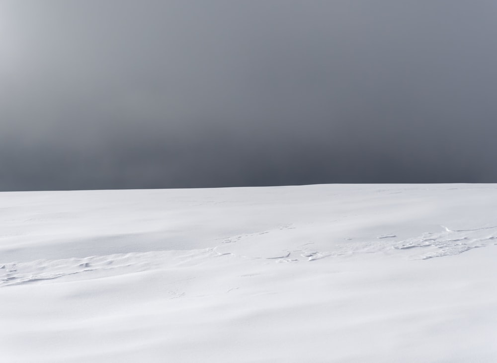 a person on skis in the snow on a cloudy day