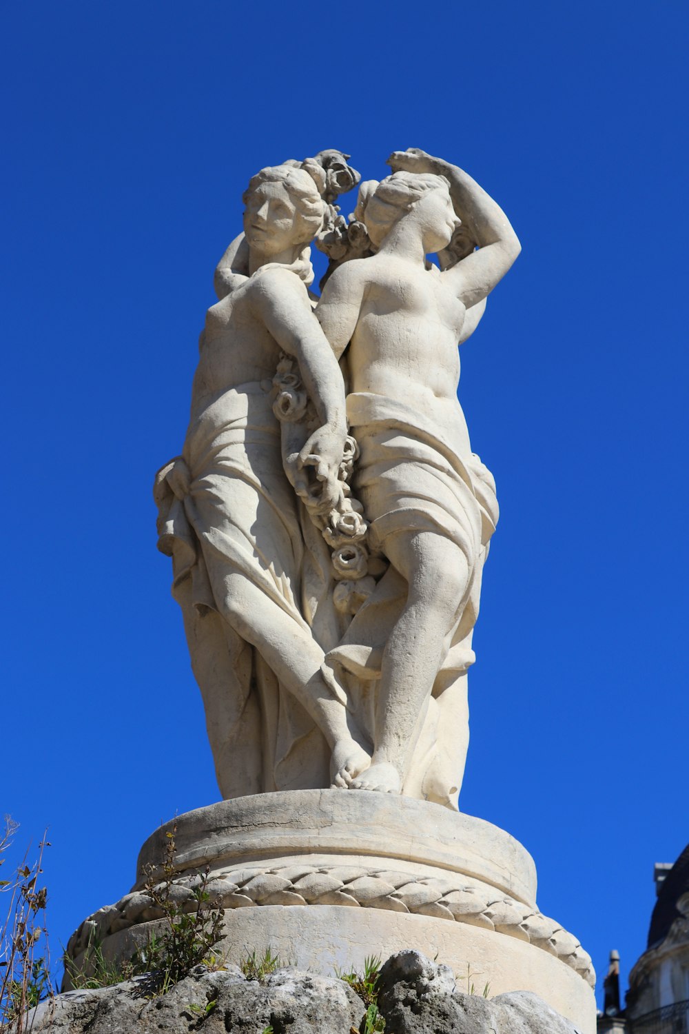 a statue of two women holding each other