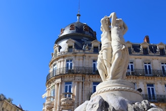 a large building with a statue in front of it