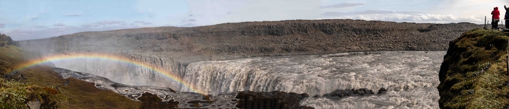 a group of people standing on top of a waterfall