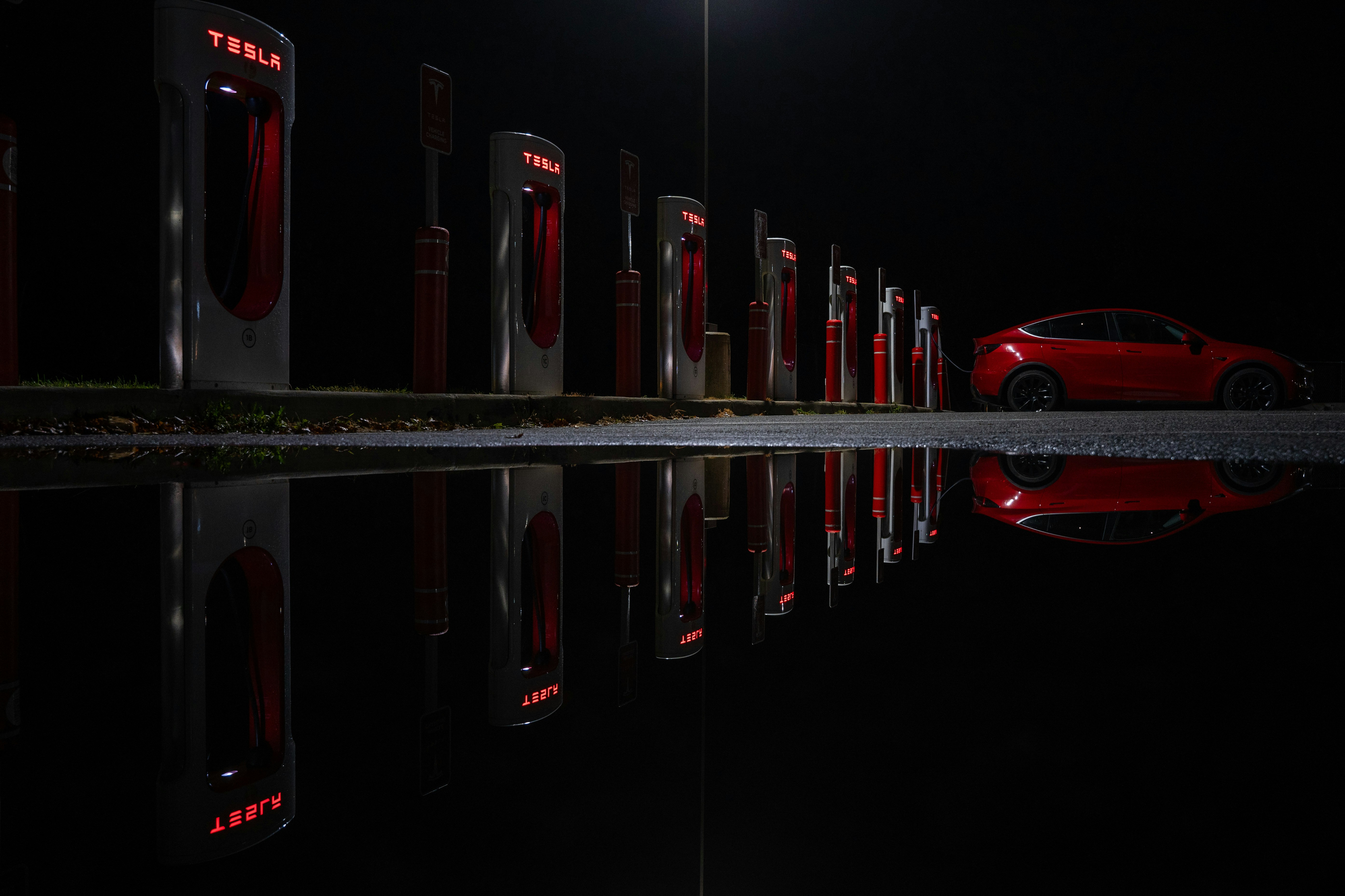 a red car parked in front of a row of red doors