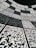 A geometric arrangement of numerous QR codes fills the perspective with a grid-like pattern. The codes are aligned in a curved fashion, creating a sense of depth and a digital, futuristic atmosphere.