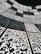 A geometric arrangement of numerous QR codes fills the perspective with a grid-like pattern. The codes are aligned in a curved fashion, creating a sense of depth and a digital, futuristic atmosphere.