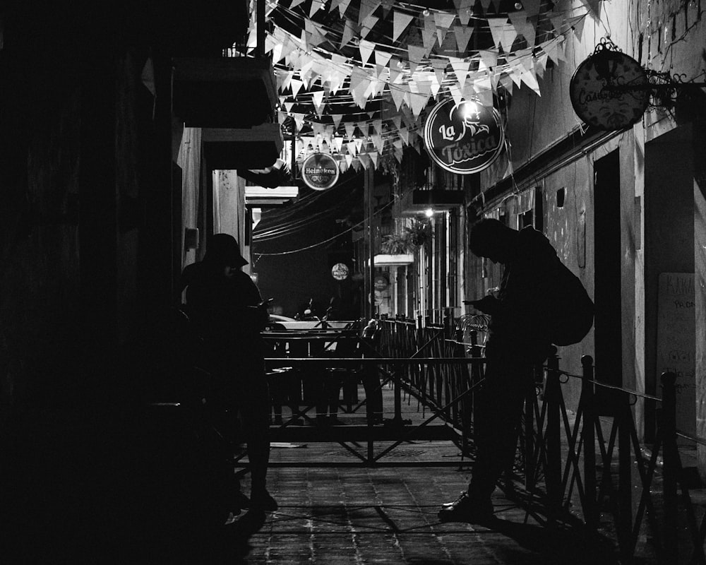 a black and white photo of a person holding an umbrella