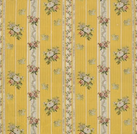 A floral patterned wallpaper featuring vertical yellow stripes with intricate floral bouquets and decorative elements in between. The flowers are arranged in small clusters with colors including white, pink, and green, adding a vintage charm to the design.
