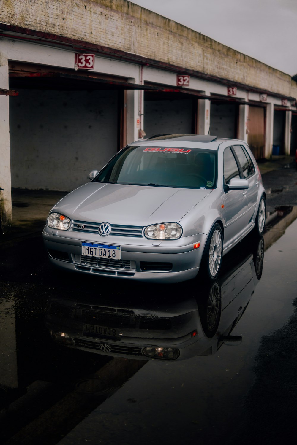 a silver car parked in front of a building