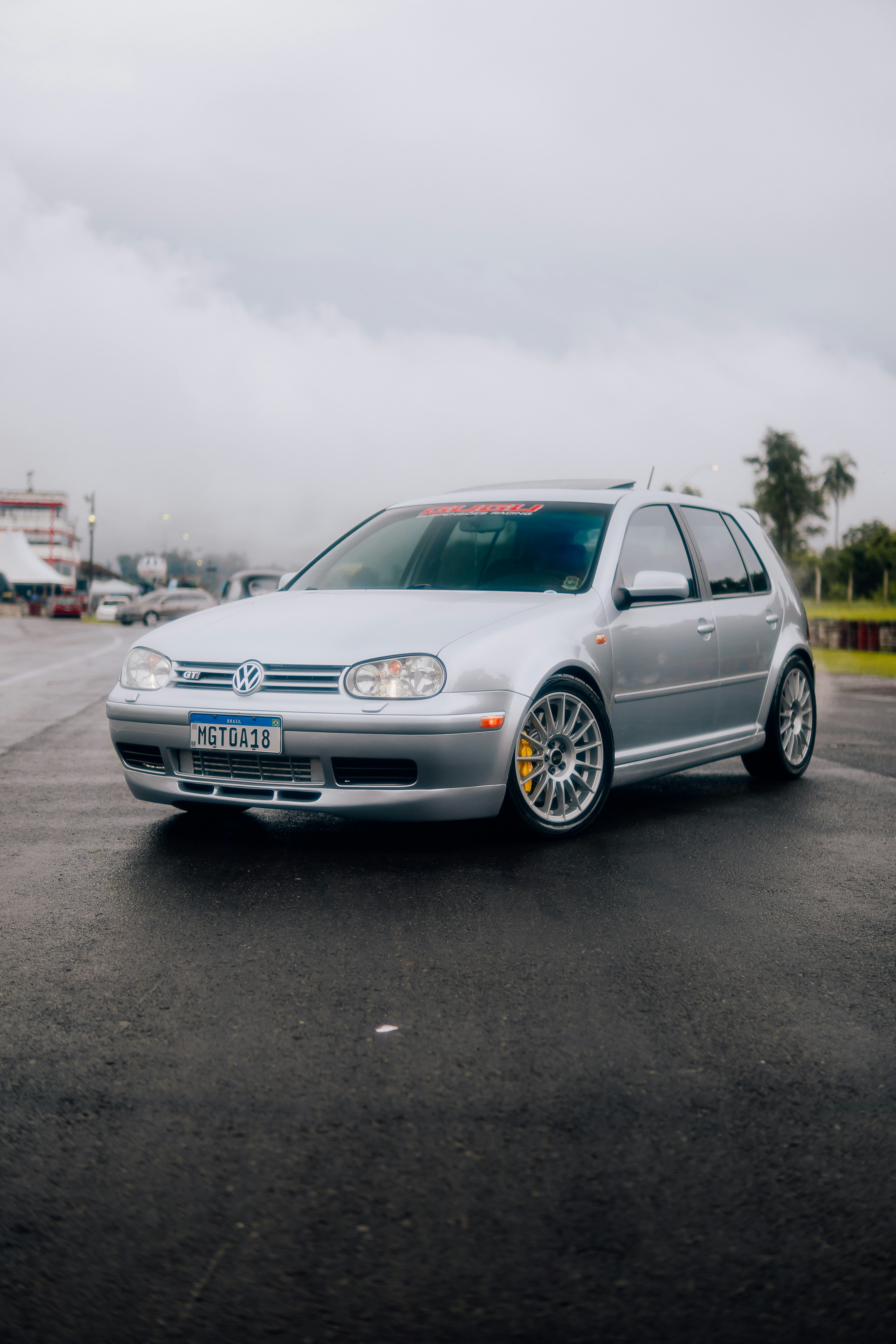 A silver car parked in a parking lot