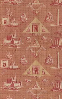 A patterned wallpaper featuring Egyptian motifs, including pyramids, sphinxes, camels, and palm trees. The design incorporates various Egyptian symbols and structures such as obelisks, making use of a reddish color palette.