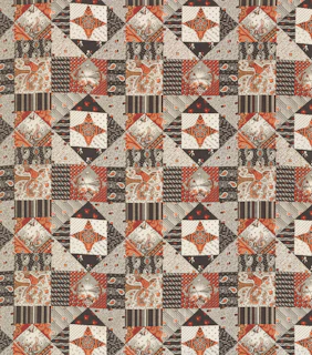 a patchwork quilt with an orange and brown design