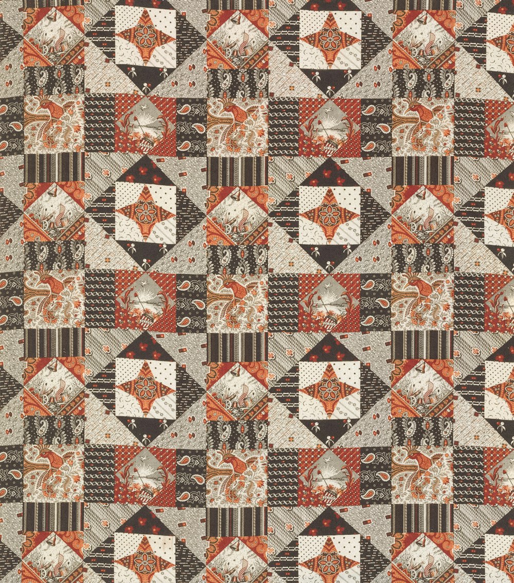 a patchwork quilt with an orange and brown design