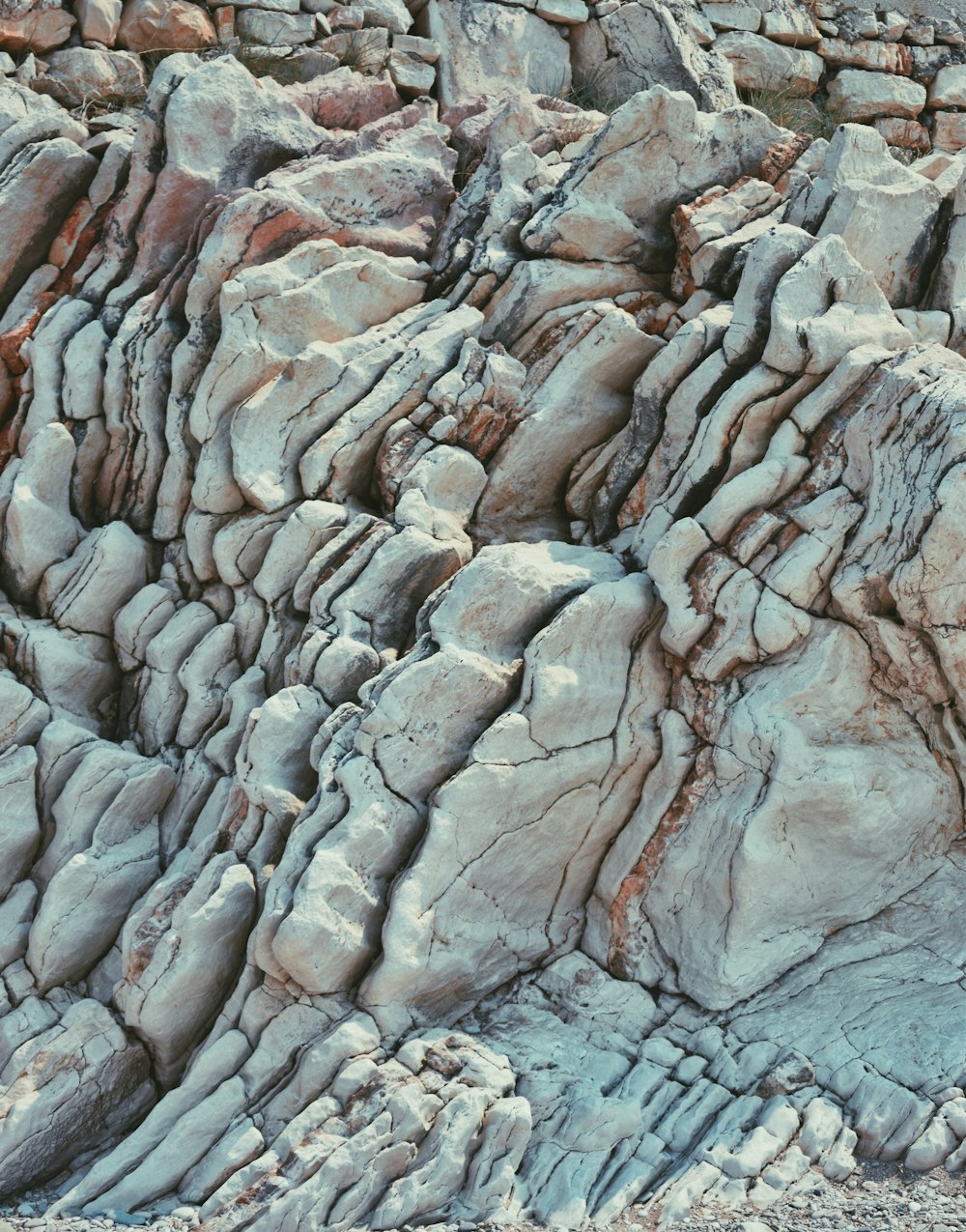 a large rock formation with a bird perched on top of it