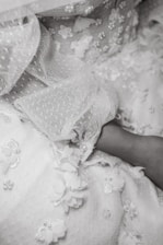 Close-up of intricate lace fabric draped elegantly over soft satin.