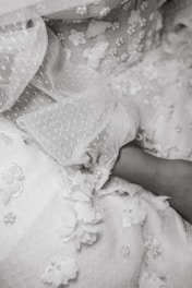 Close-up of soft textures and delicate embroidery on modest dress fabric.