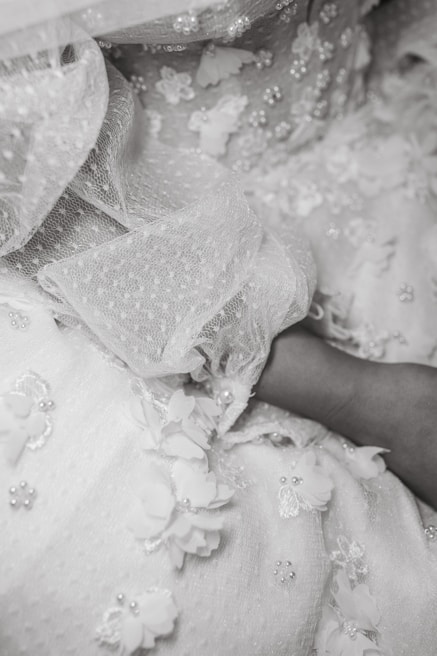 Close-up of delicate lace detailing on a soft pastel blouse