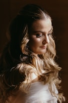 Elegant hairstyle featuring tape-in extensions with a natural flow under soft lighting.