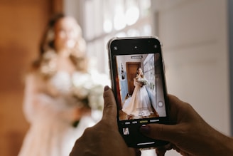 A photographer capturing a joyful wedding moment with natural light.