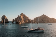 a group of boats floating on top of a body of water