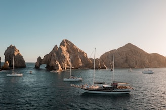 a group of boats floating on top of a body of water