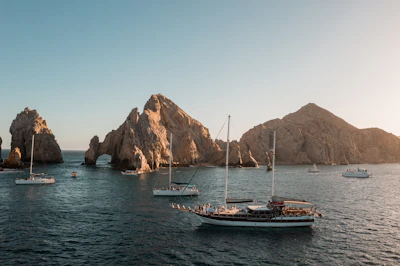 a group of boats floating on top of a body of water