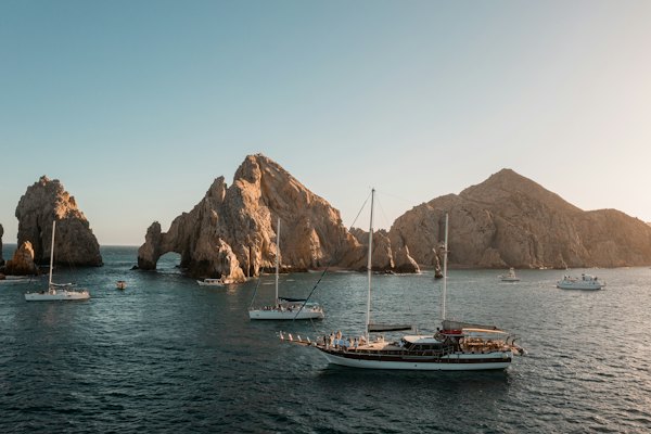 A group of boats floating on top of a body of water — Los Cabos, Mexico