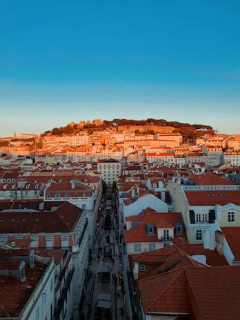 A panoramic view of elegant European city streets lined with historic architecture at sunset.