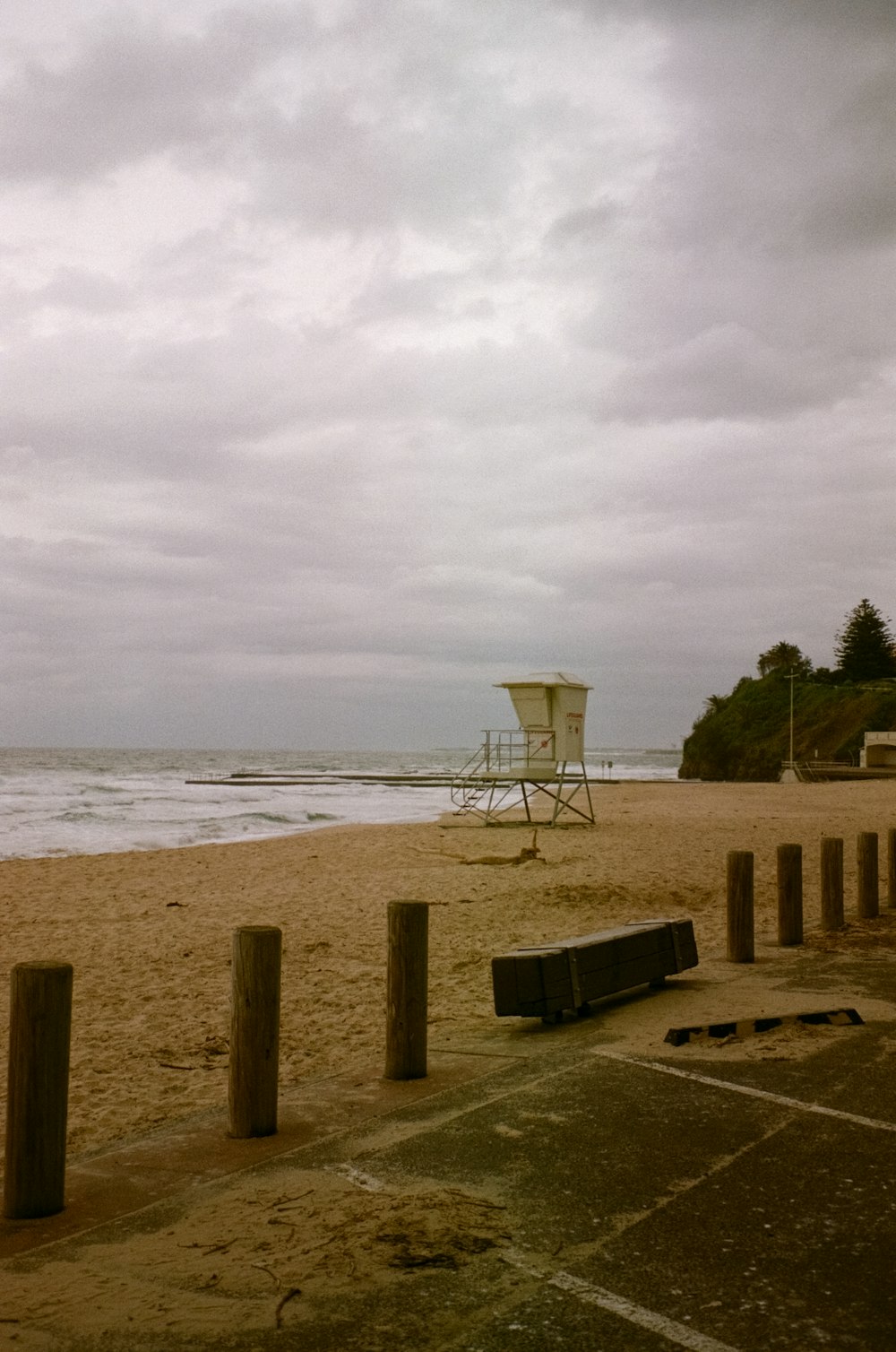 a beach with a lifeguard chair and a life guard tower