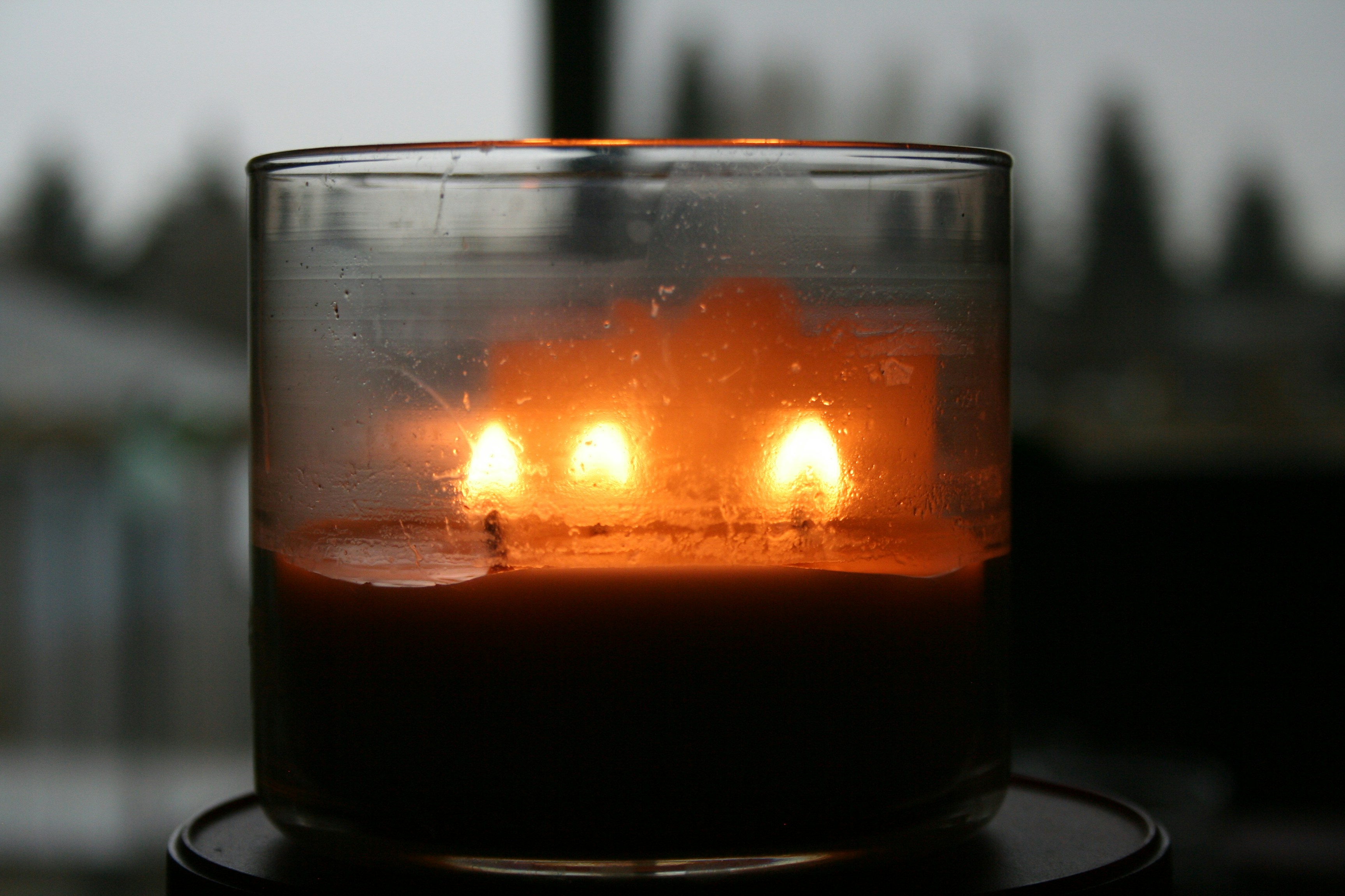 Lit candle in glass