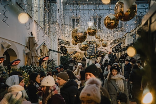 A festive street market alive with colors, lights, and joyful visitors.