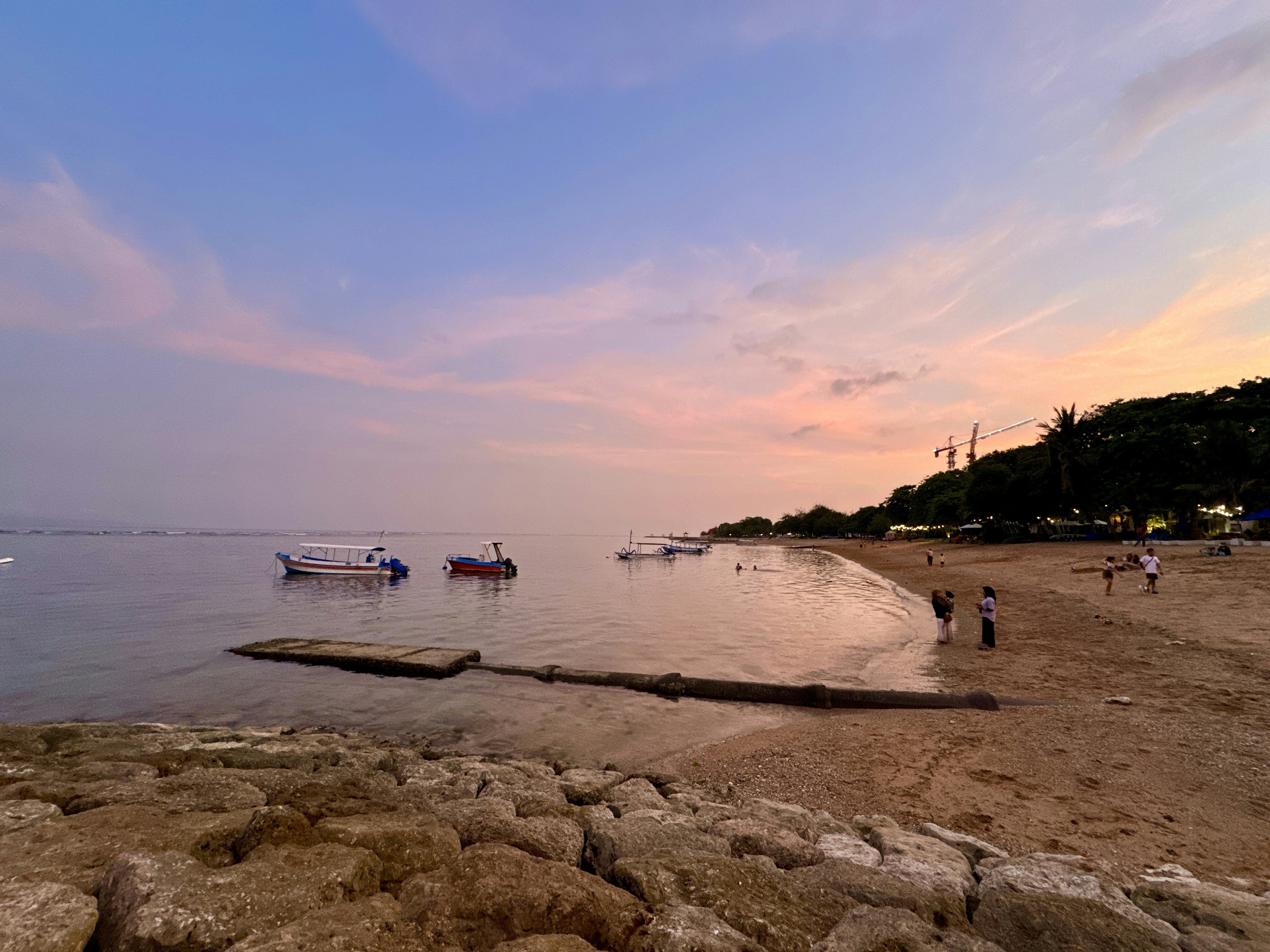 a group of boats floating on top of a body of water