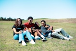 A group of friends laughing while solving a puzzle outdoors.