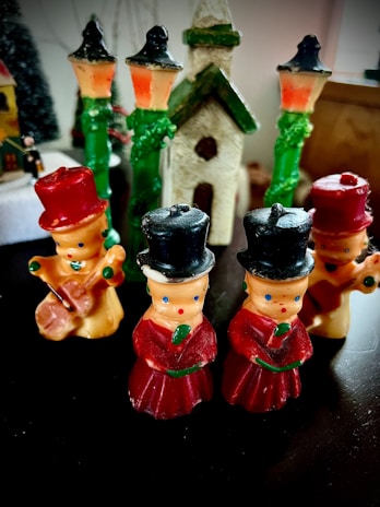 A group of carolers singing joyfully on a snowy street in Villalba during the holiday season.