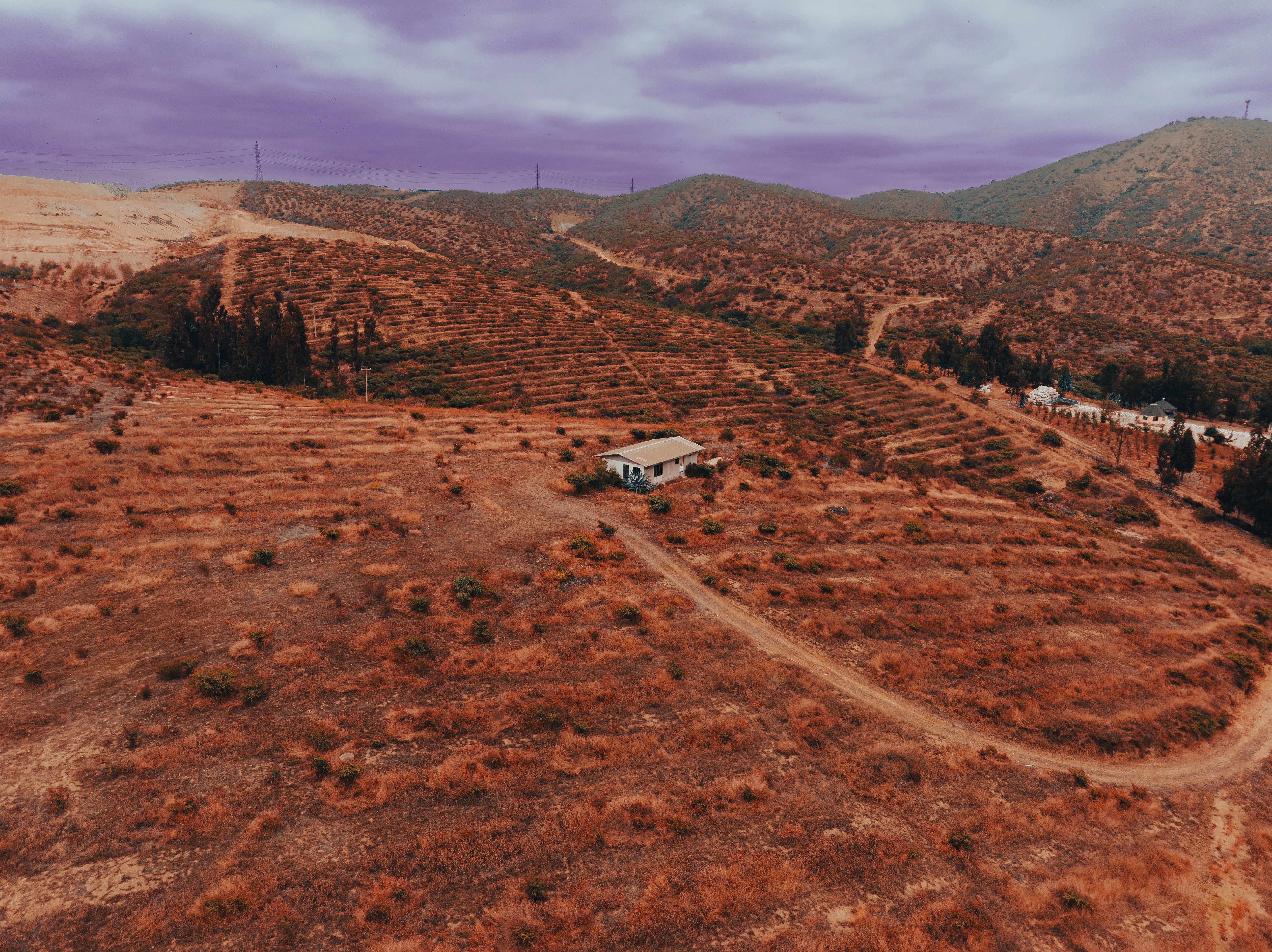 an aerial view of a dirt road in the middle of a field