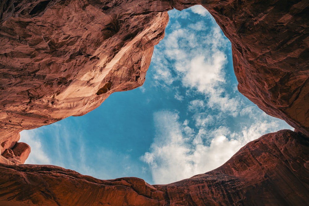 a view of the sky from inside a cave