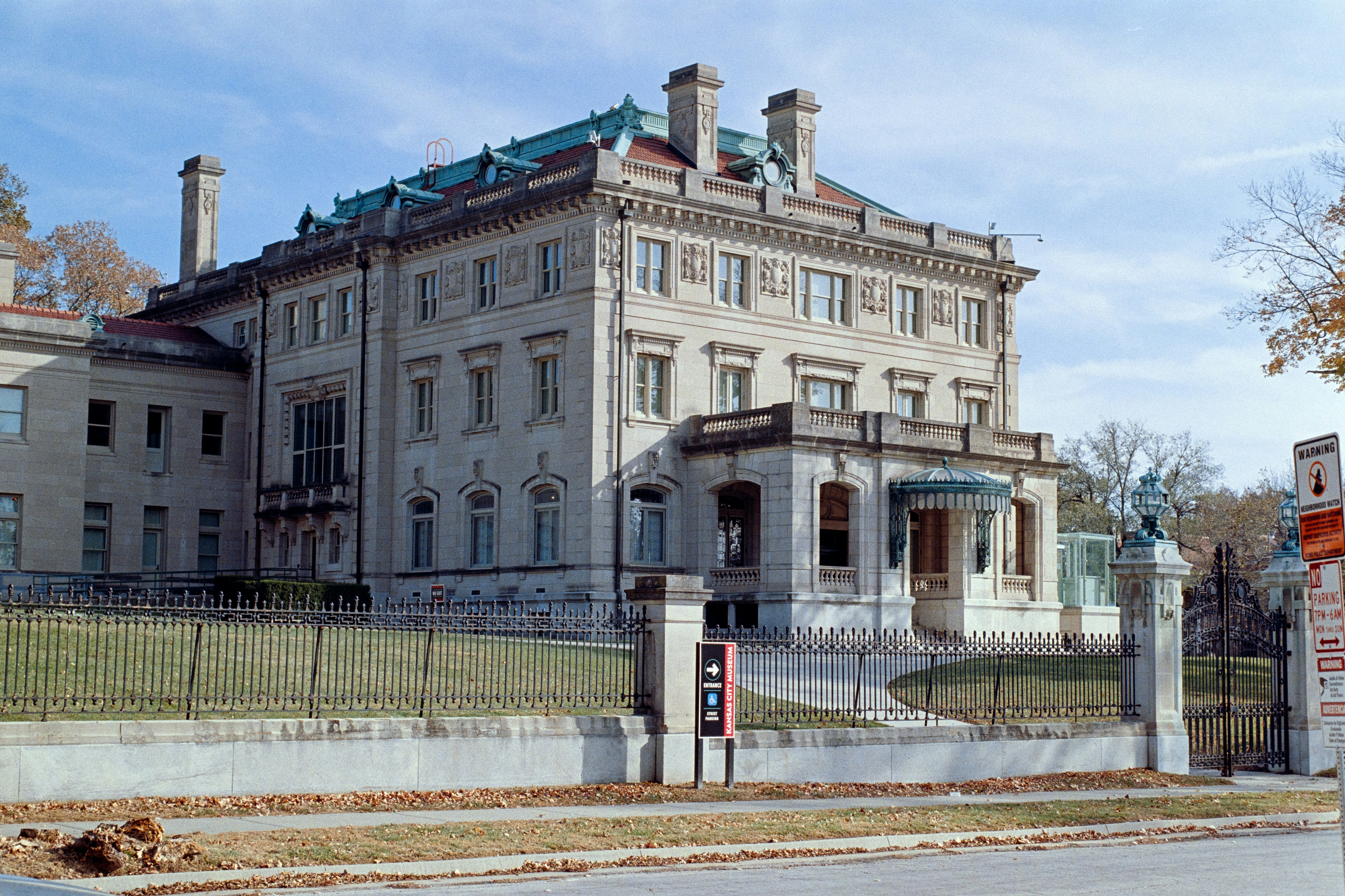a large building with a fence around it, 