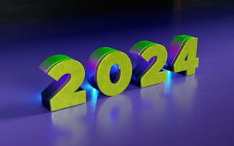 Large, metallic 3D numbers displaying '2024' are set against a smooth, gradient background transitioning from dark purple to a lighter blue. The numbers have a shiny finish with a greenish hue and casts a soft glow.